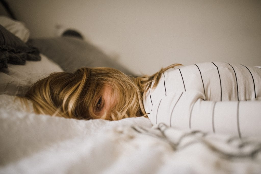 fatigued woman on bed